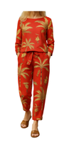 Co-ord of the Wild rust-hued set with golden palm prints, featuring a long-sleeve top and matching tie-waist pants.