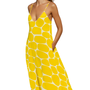 Woman wearing a yellow pebbled print flowy dress with thin straps, titled Hello Yello Maxi, posing with eyes closed.